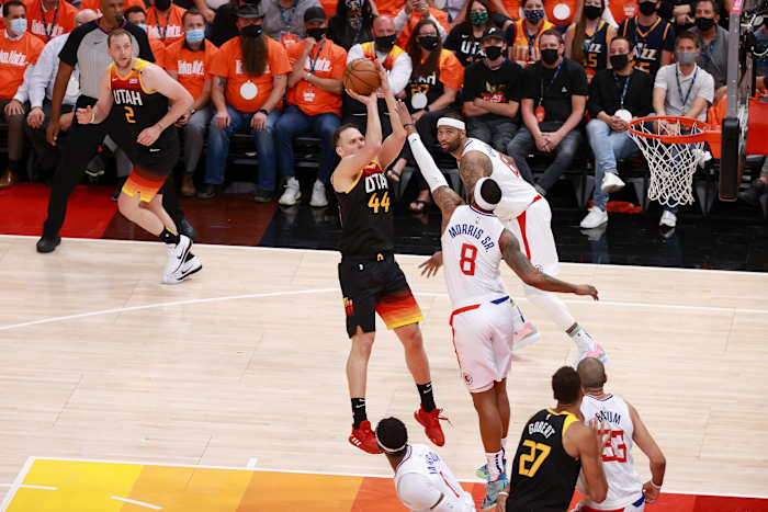 Bojan Bogdanovic (44) scores over Marcus Morris (8)